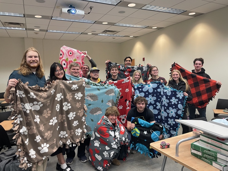 Our group holding the Tie Blankets we made for the local Animal Shelter